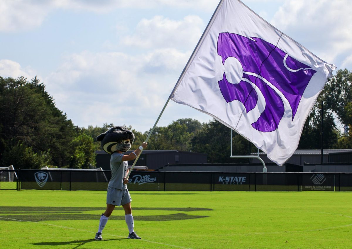 Willie the Wildcat waves the K-State flag before the soccer game against ASU on Sept. 27 at Buser Family Park.