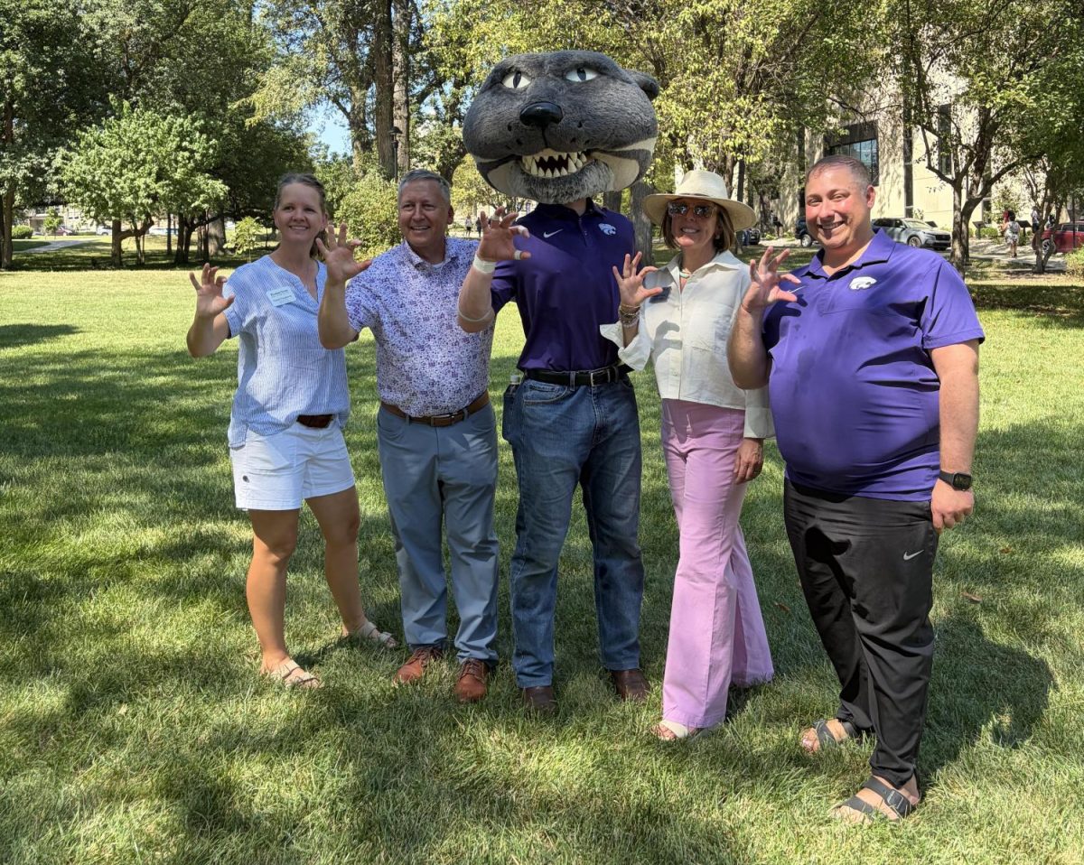 [left to right] Casey Daugherty, President's Residence manager, Richard Linton, president of K-State, Willie the Wildcat, Sally Linton, first lady of K-State and Brett Engleman, events director to the president and first lady stand and smile together for a photo at Lunch with the Lintons on Sept. 4.