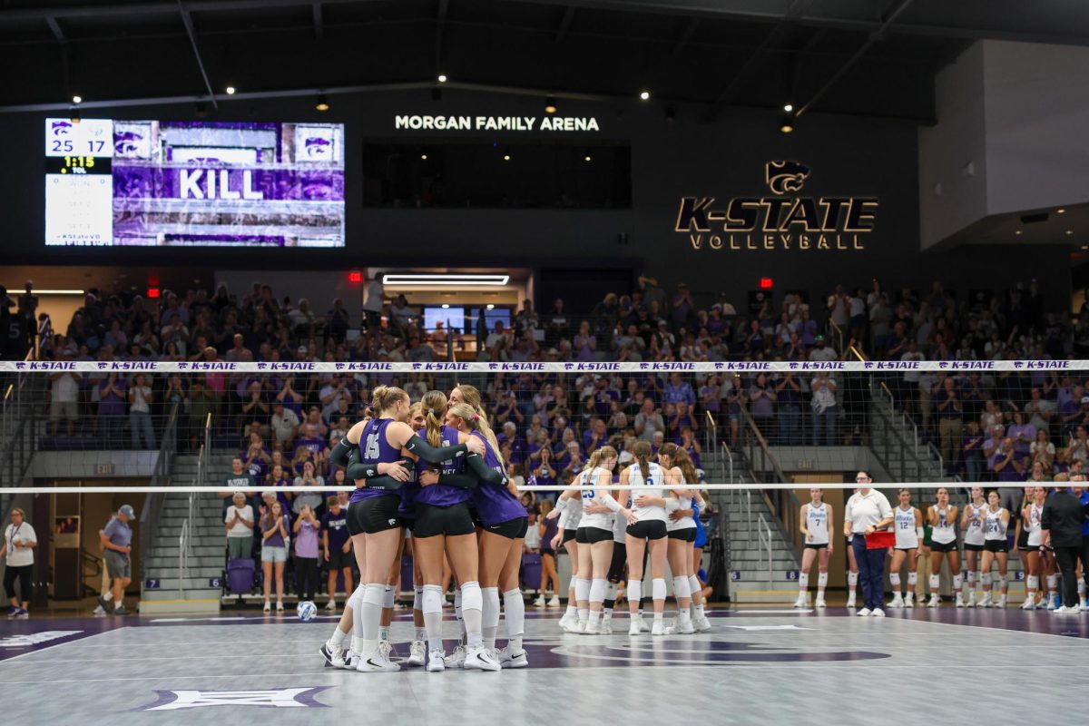 K-State huddles they score a kill and win the first set against Drake on September 7.