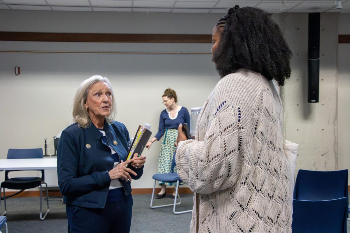Democratic candidate for Kansas House District 66 Sydney Carlin speaks to a community member after the Indivisible MHK Candidate Forum. 