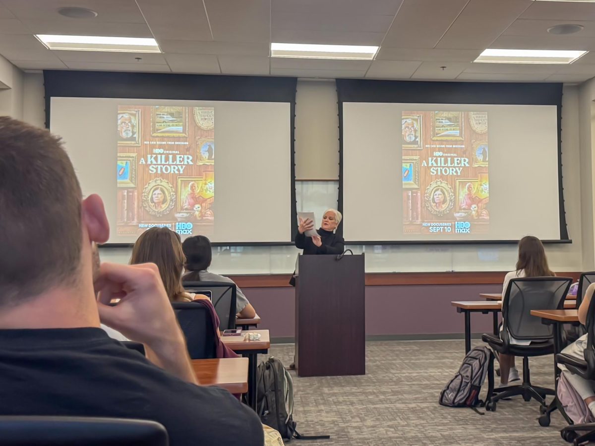 Eileen Umbehr holds up a document from the TV show "48 Hours" and presents about the Dana Chandler case.