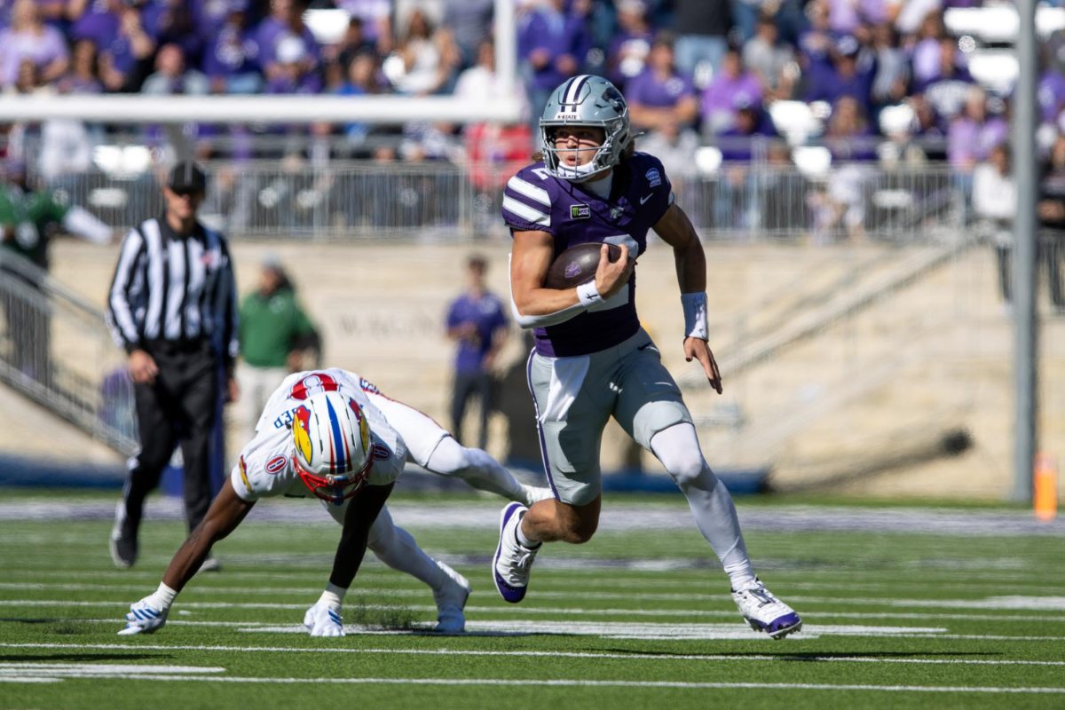 Senior quarterback Avery Johnson (2) runs the football after breaking from an attempted tackle. The Wildcats defeated the Jayhawks in the Dillons Sunflower Showdown for the 18th consecutive year. The final score was 35-24 at Bill Snyder Family Stadium on Oct. 17.