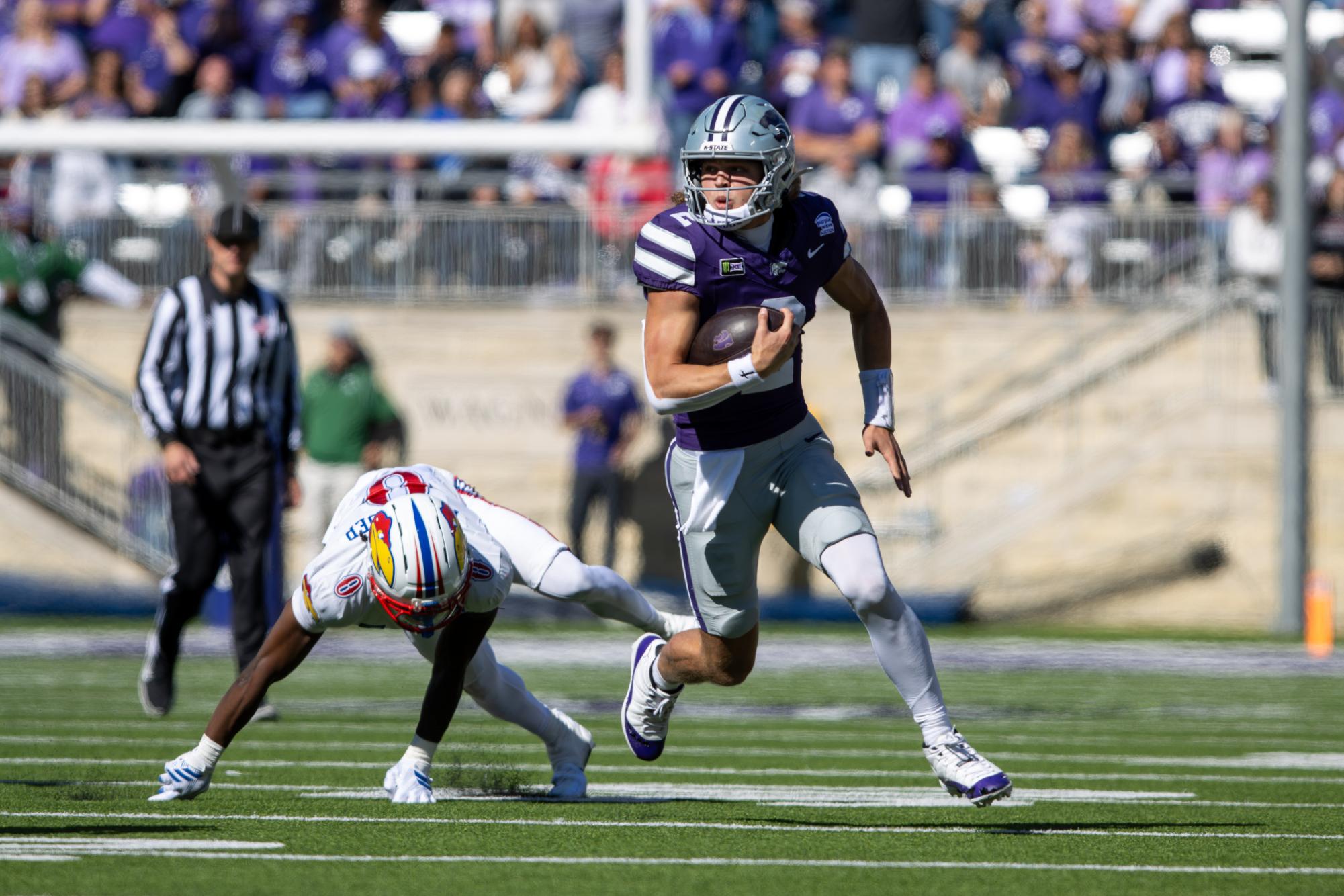 Senior quarterback Avery Johnson (2) runs the football after breaking from an attempted tackle. The Wildcats defeated the Jayhawks in the Dillons Sunflower Showdown for the 18th consecutive year. The final score was 35-24 at Bill Snyder Family Stadium on Oct. 17.