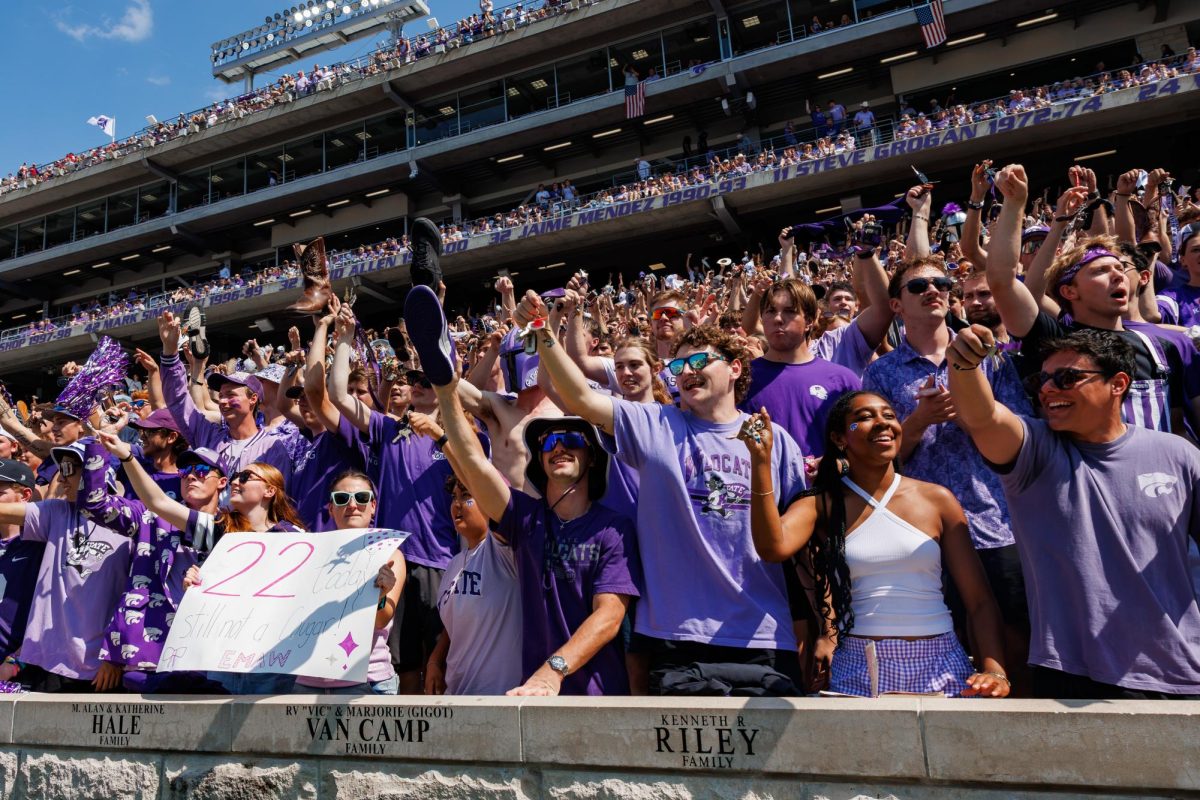 Students hold up and shake their keys in the student section prior to the third quarter kickoff against Washington State on Sept. 12 at Bill Snyder Family Stadium.