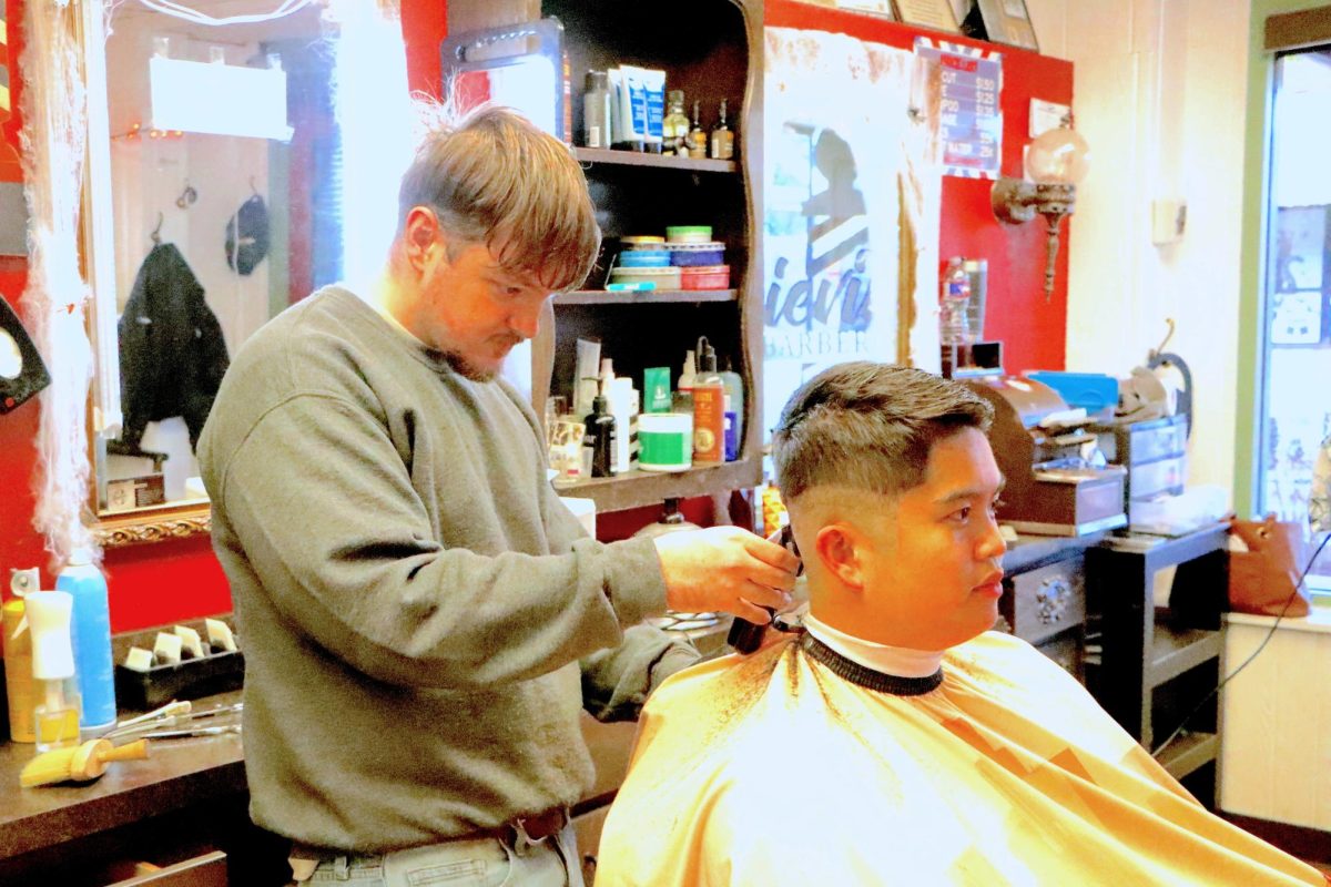 A barber at the Aggieville Barbershop in Manhattan cuts a client's hair on Oct. 20.