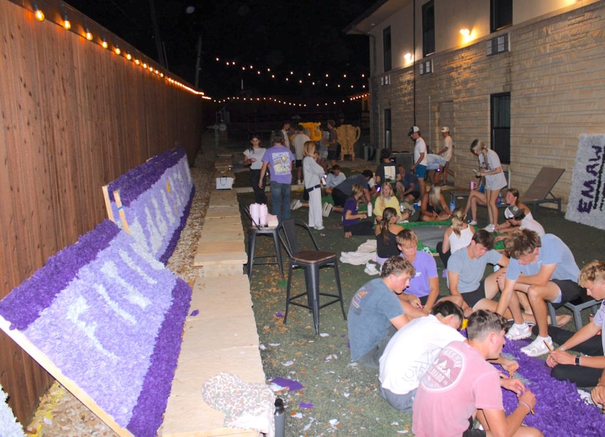 Phi Gamma Delta, Delta Sigma Phi and Delta Delta Delta put the finishing touches on their pomping in the backyard of Phi Gamma Delta during Monday night of homecoming week. 