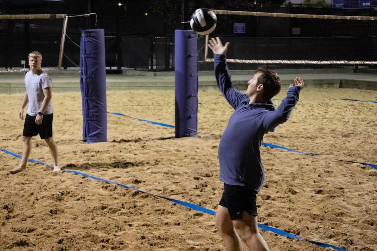 Will Lingenfelser, senior in integrative physiology, serves the ball during a sand volleyball game at the Chester E. Peters Recreation Center on Oct. 15. St. Isidore’s students meet weekly to spend time in friendly competition and get away from busy college life.